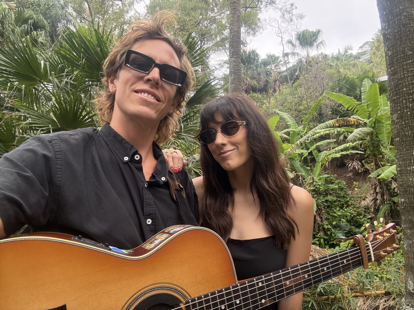 Elle May and Mitch performing outdoors at a wedding